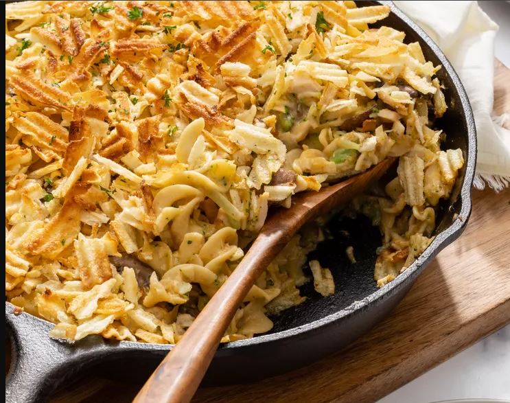 A warm and golden tuna casserole topped with crispy breadcrumbs, with steam rising, representing the comfort and flavor of a classic tuna casserole recipe.